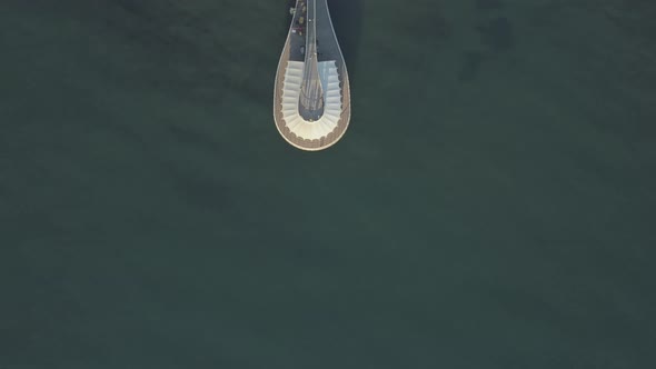 Top Down Drone Shot of a Pier during Summer Season with People, Beach and Sea