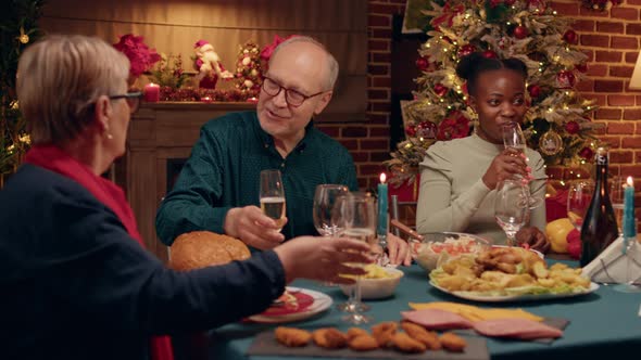 Happy Elderly Man Talking with Wife While Enjoying Christmas Dinner Table