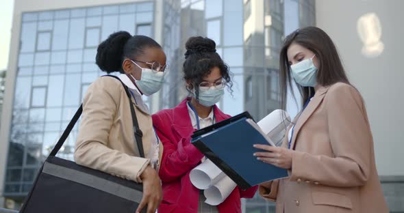 Female Architects Looking at Blueprint on Construction Site