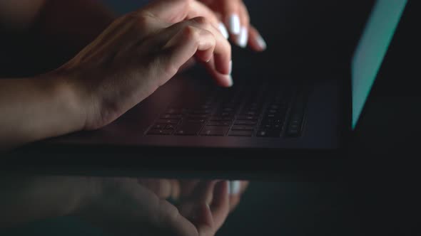 Hands or Woman Office Worker Typing on the Keyboard at Night