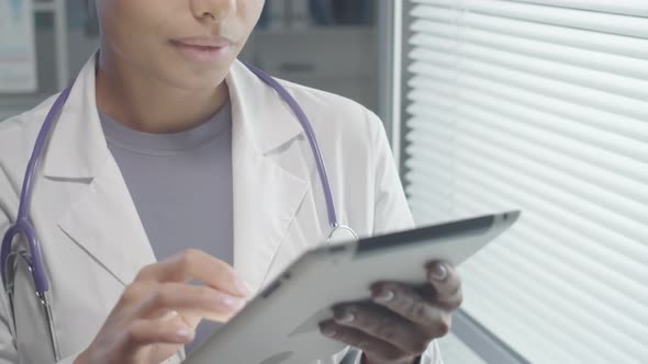 Mixed Raced Female Practitioner Using Digital Tablet