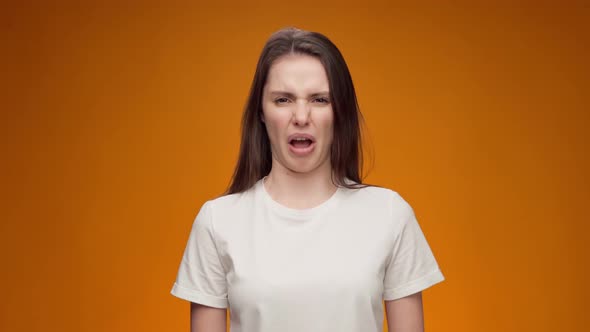 Young Woman Expressing Aversion Rejection Negative Attitude Against Yellow Background