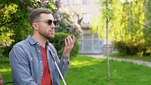 Blind Man with Disability Using Digital Assistant and Ease of Access Functions on Smartphone