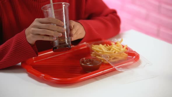 Female Customer Drinking Carbonated Water From Plastic Glass, Unhealthy Lunch