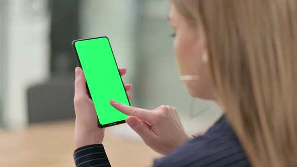 Rear View of Businesswoman Holding Smartphone with Chroma Screen 