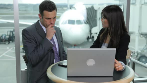 Businessman and Businesswoman have meeting at airport