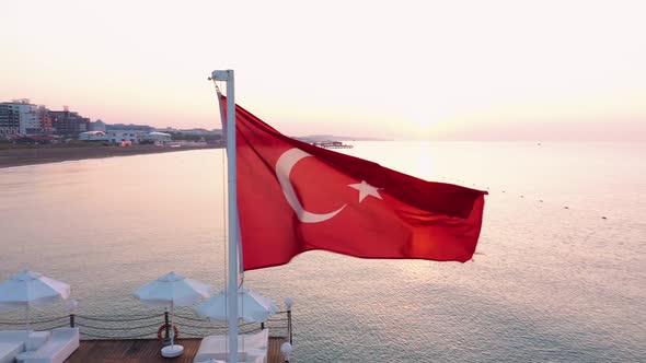 Turkish Flag Is Waving on Wind Against Sea at Sunset.