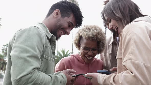 Happy Friends Having Fun Together While Watching Funny Videos on Smart Phone