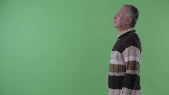 Profile View of Happy Mature Japanese Man Smiling Ready for Winter