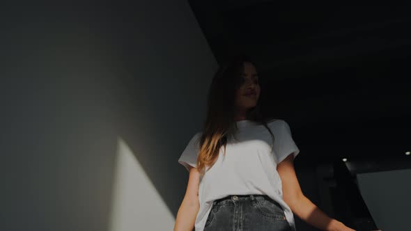 A Woman Descends the Stairs of the Second Floor of the Apartment at Dawn