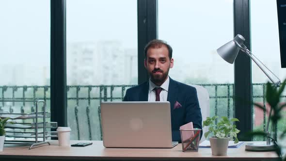 Portrait of Handsome Businessman at His Desk