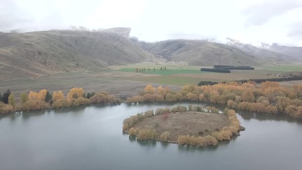 Serene mountain valley with lake and colorful autumn trees