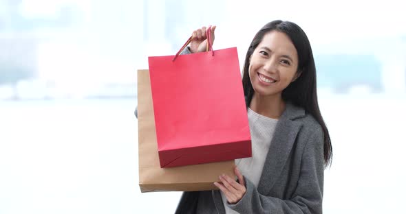 Woman use of smart phone with shopping bag