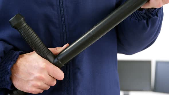 Security guard holding baton on white background