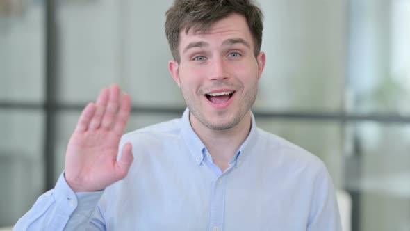 Portrait of Young Man Waving Welcoming