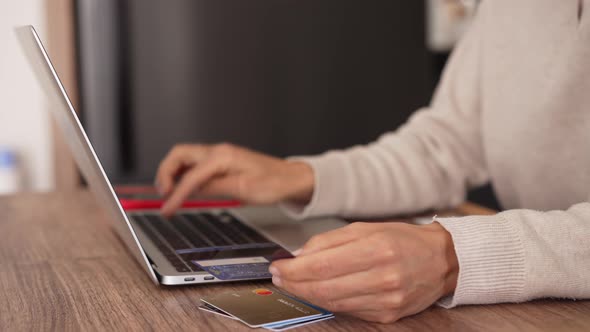 Upset Young Woman Using Online Banking Service Problem with Blocked Credit Card Using Laptop