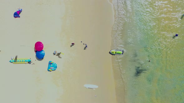 Aerial: Fly out from the beautiful beach. PHUKET, THAILAND Patong beach. sandy beach and blue transp