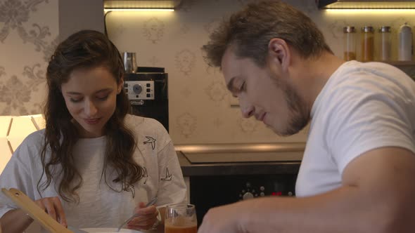 Young Attractive Couple Having Appetizing Dinner at Home