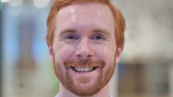 Close Up of Smiling Face of Redhead Man Looking at the Camera