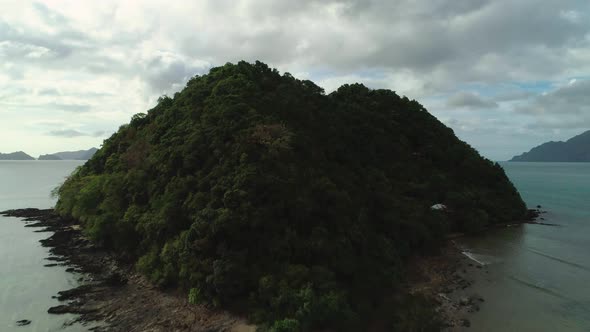 Aerial flyover of a small tropical island in in El Nido, Philippines. Stunning archipelago in the ba