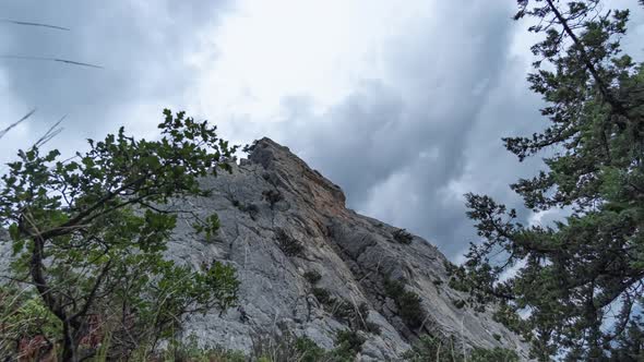 Timelapse of moving clouds above a mountain