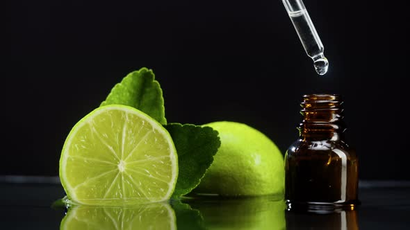 Dripping Oil From Pipette Into Bottle Closeup Lime Juice