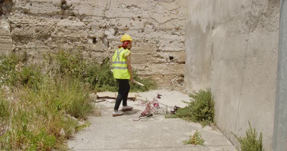 Young girl rescuer finds a stroller of refugees in the Ukrainian war destroyed city