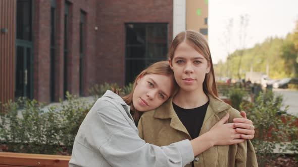 Portrait of Twin Sisters Posing Outside