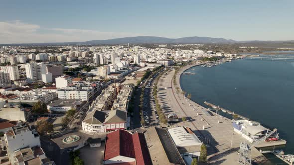 Portimao city and seafront promenade, Portugal. Aerial backward ascendent