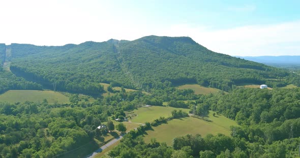 Panorama Aerial View of Summer Green Trees Forest in Daleville Town with Valley Mountains in West