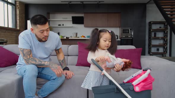 Asian Dad Babysitting Toddler Daughter Playing with Kids Stroller