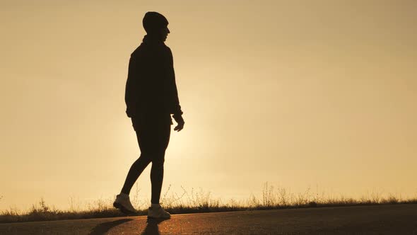 Silhouette Fitness Sport Women Running on Road at Sunset