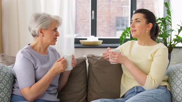 Senior Mother and Adult Daughter Drinking Coffee