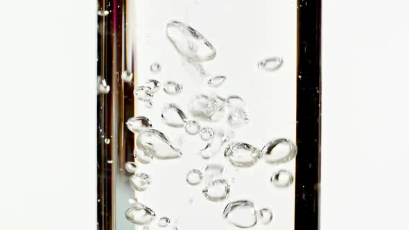 Macro Shot of Clear Water Air Bubbling By Pouring Water Inside Clear Pipette on White Background