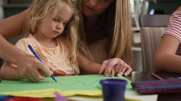 Mother and daughters painting together