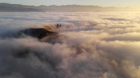 Aerial time lapse of low clouds at dawn