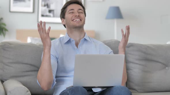 Handsome Young Man Cheering for Results of Project