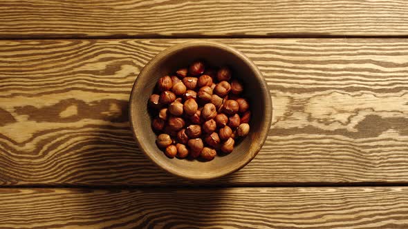 Peeled hazelnuts appear in wooden cup and full this cup