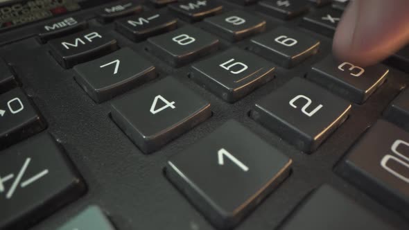 Close Up Shot of Businesswoman or Female Accountant Hand Using a Calculator Doing the Math