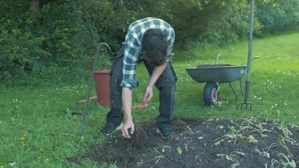 Young man working in field res rock