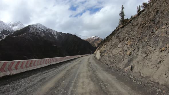 Off road car running on snowing mountain trail on winter day