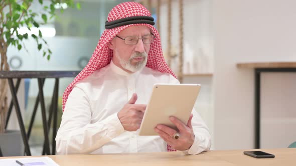 Professional Senior Old Arab Businessman Doing Video Call on Tablet 