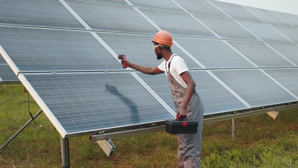 Side View of African American Man Standing Outdoors and Measuring Heat of Solar