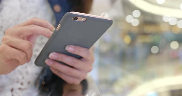 Woman use of mobile phone in shopping mall