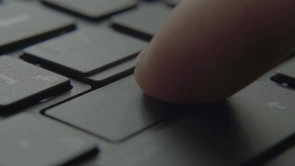 The Finger Presses the Enter Button on the Keyboard