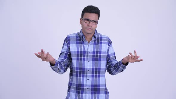 Confused Young Indian Hipster Man Shrugging Shoulders