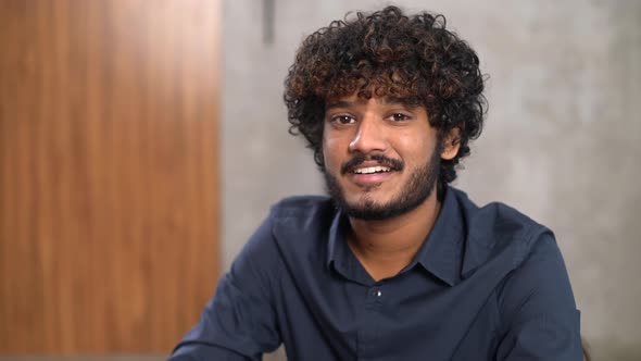 Video Portrait of Confident Smart Indian Male Employee Sitting at the Desk in Modern Office