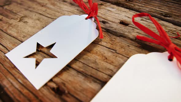 Close-up christmas tag kept in row on wooden plank