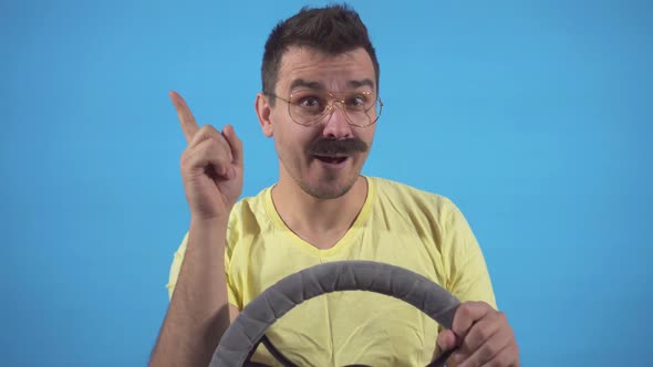 Finding a Solution Male Freak with Mustache Driving a Car on a Blue Background Isolate
