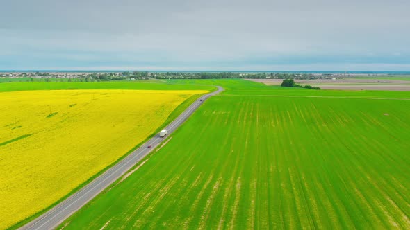 Aerial View Of Highway Road Through Field And Summer Wheat Fields Landscape